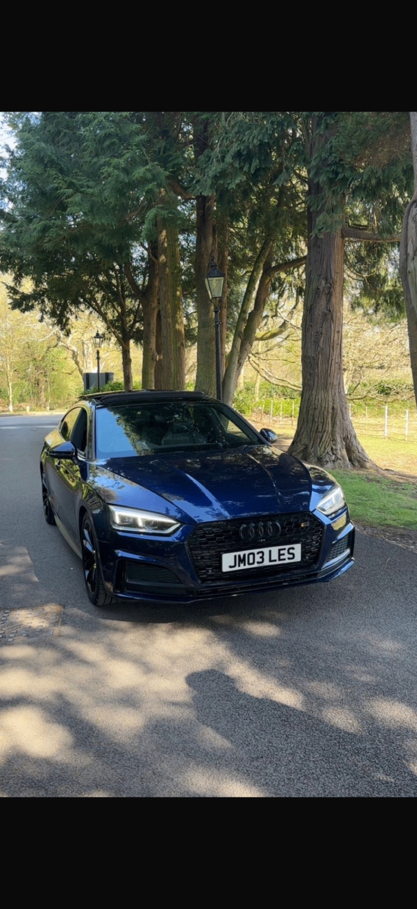 Audi S5 front three-quarter view on a quiet road