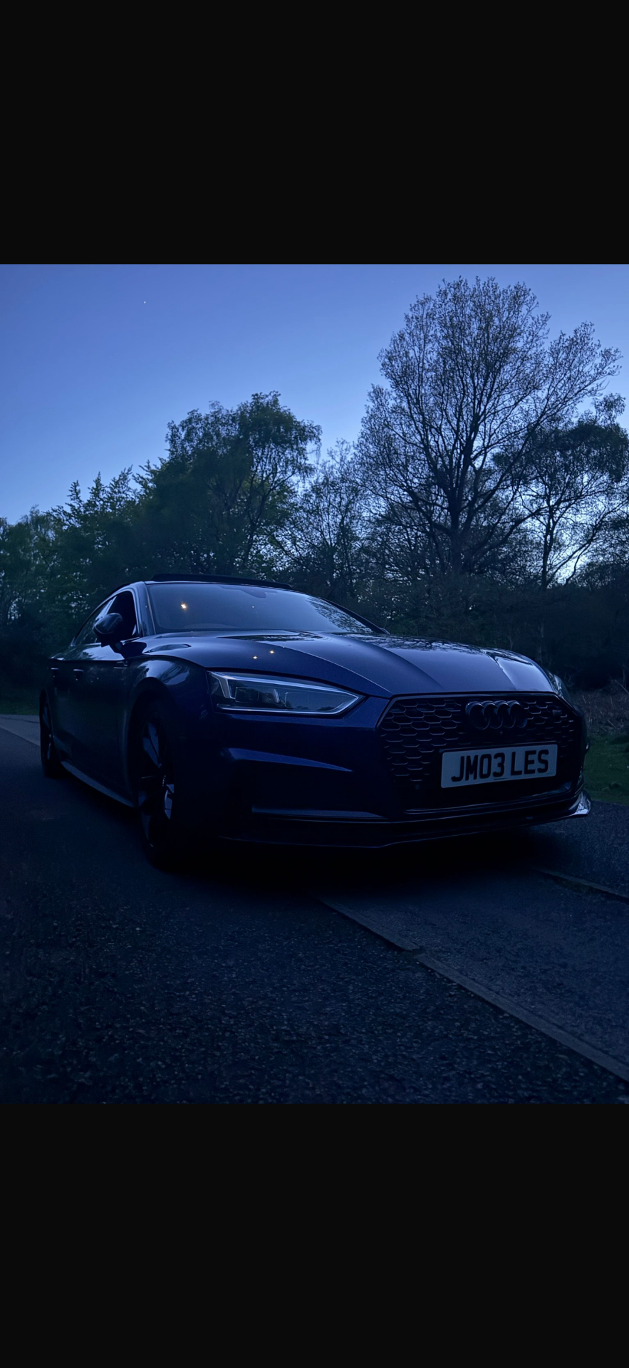 Audi S5 front three-quarter view at dusk