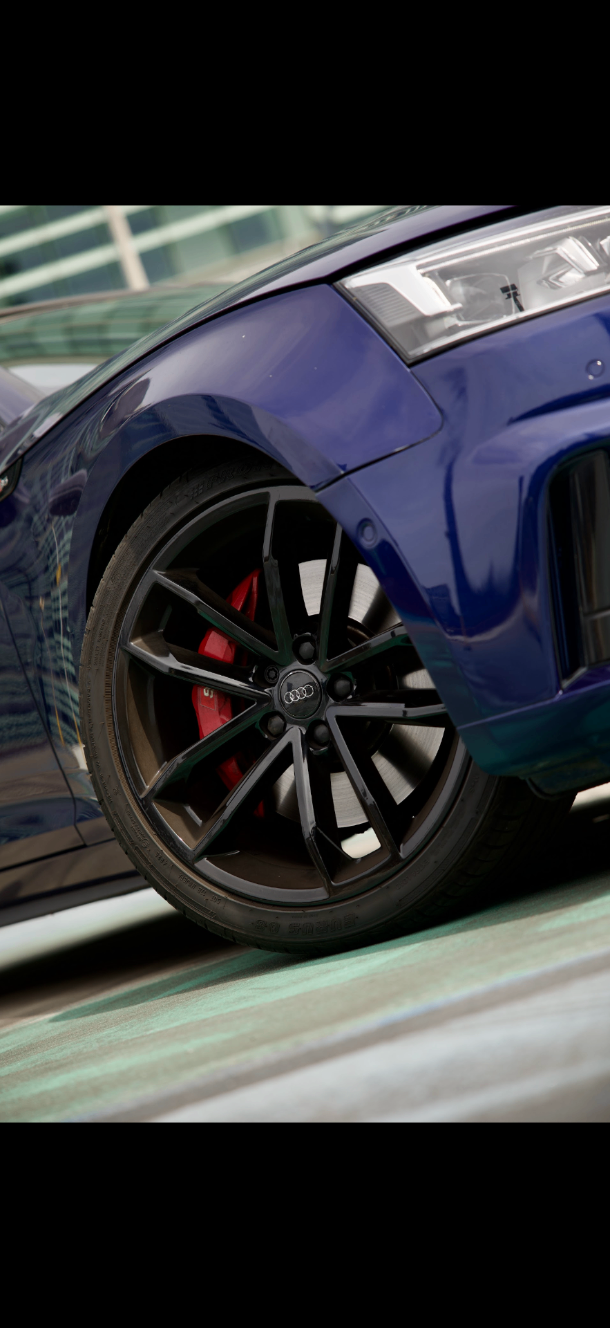 Audi S5 black alloy wheel with red brake caliper close-up